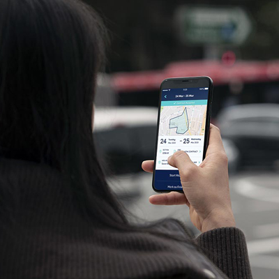 woman holding a phone using the ivehub app