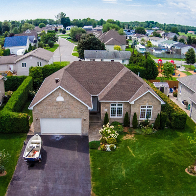 house from above with a boat parked in the driveway